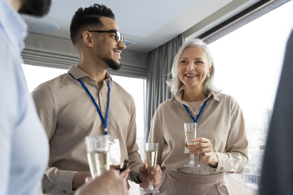 Business professionals networking with champagne aboard upscale yacht interior setting