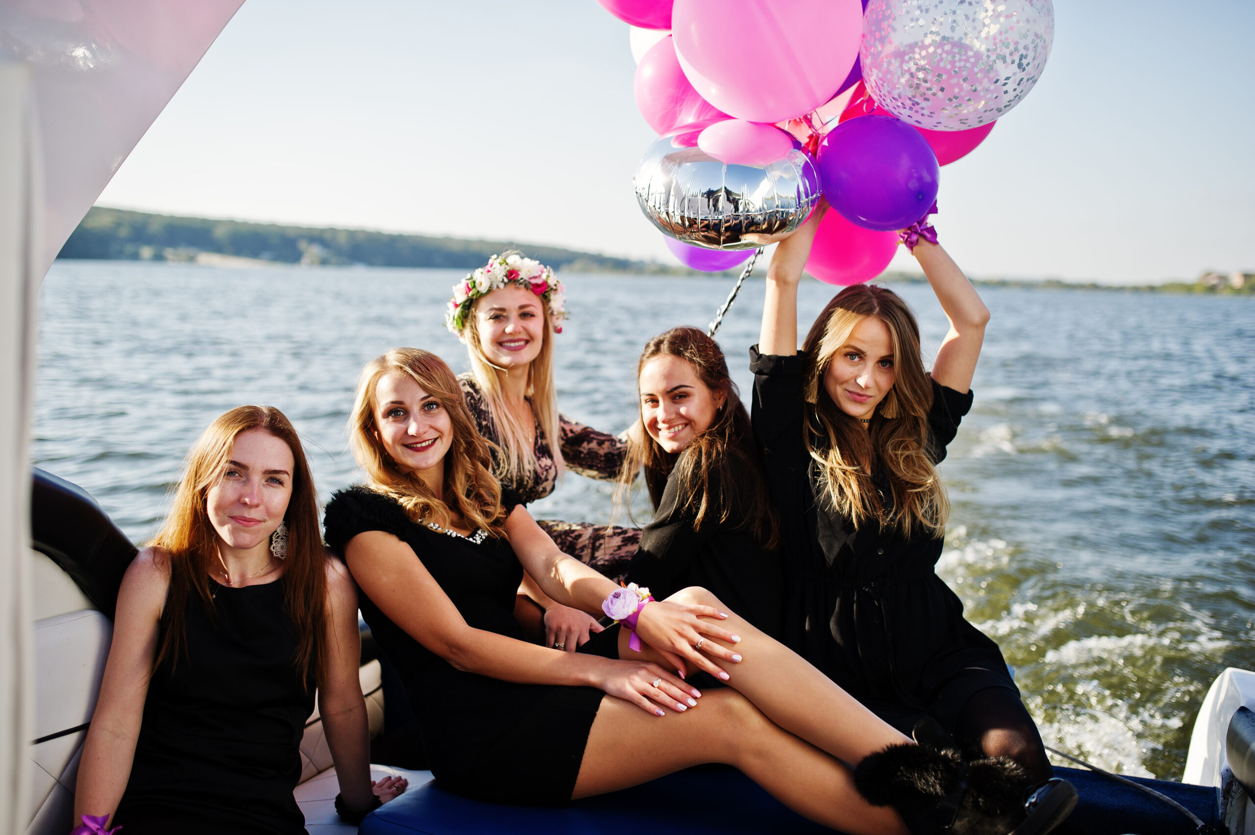 Group of women celebrating with balloons at party or event indoors