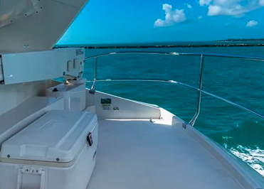 Yacht deck seating area with ocean view and bright turquoise water